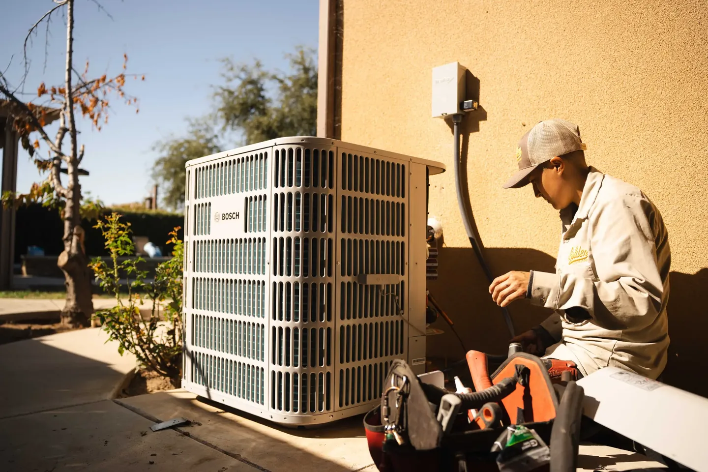 Golden Valley Heating and Air technician servicing outdoor air conditioning equipment — photo 4