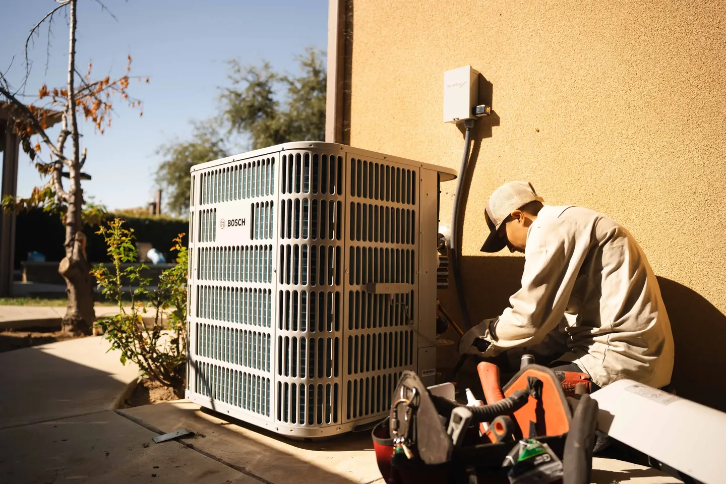 Golden Valley Heating and Air technician servicing outdoor air conditioning equipment — photo 5