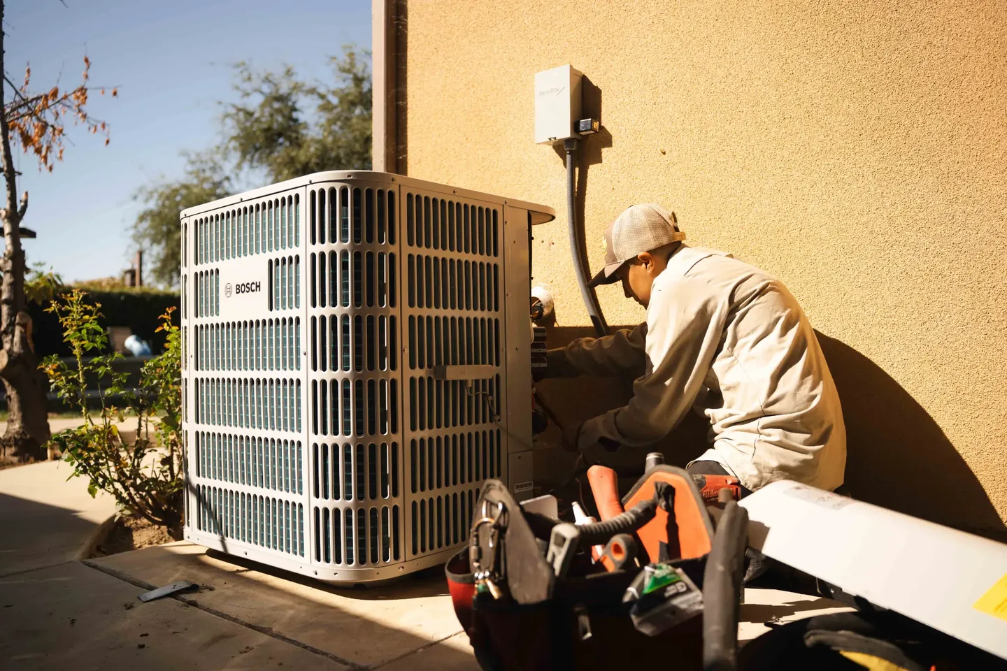 Golden Valley Heating and Air technician servicing outdoor air conditioning equipment — photo 6