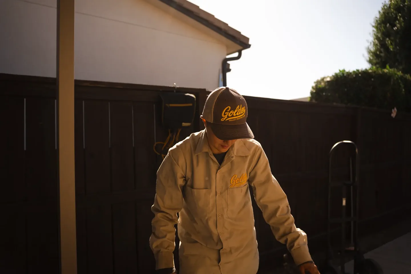Golden Valley Heating and Air technician servicing outdoor air conditioning equipment — photo 7