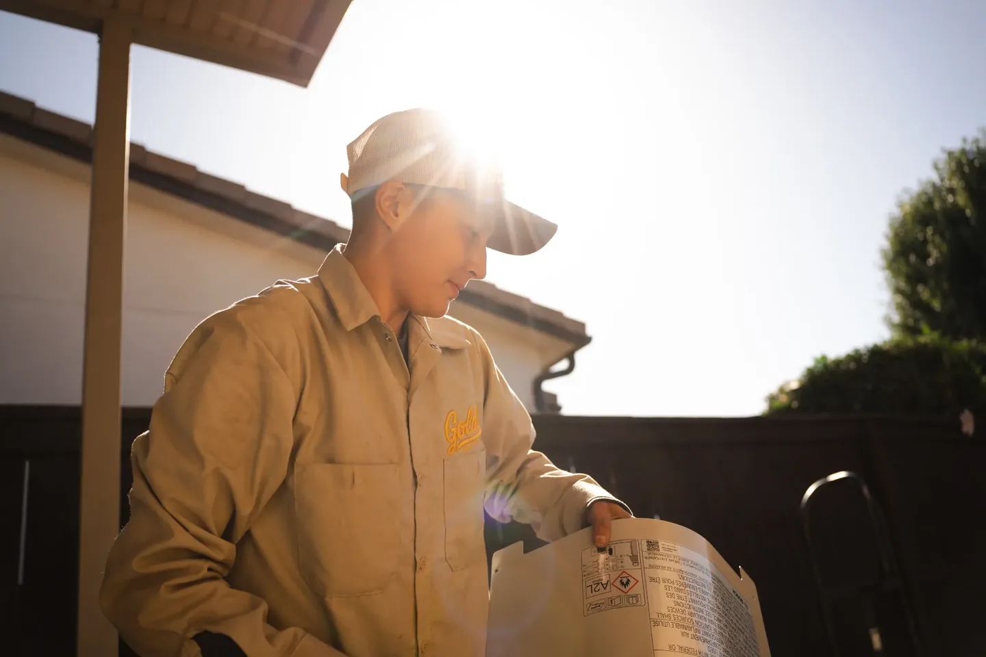 Golden Valley Heating and Air technician servicing outdoor air conditioning equipment — photo 8