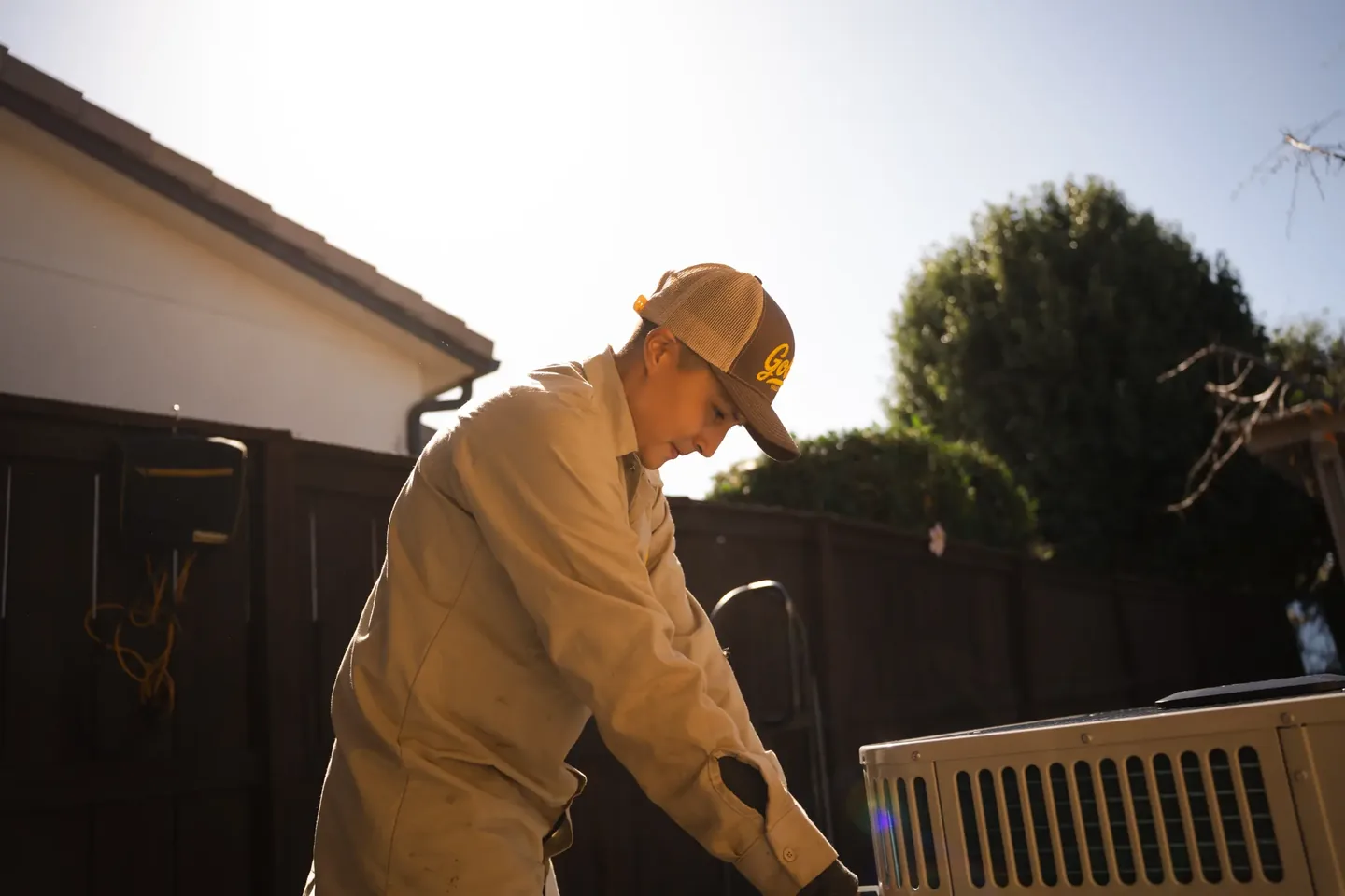 Golden Valley Heating and Air technician servicing outdoor air conditioning equipment — photo 9