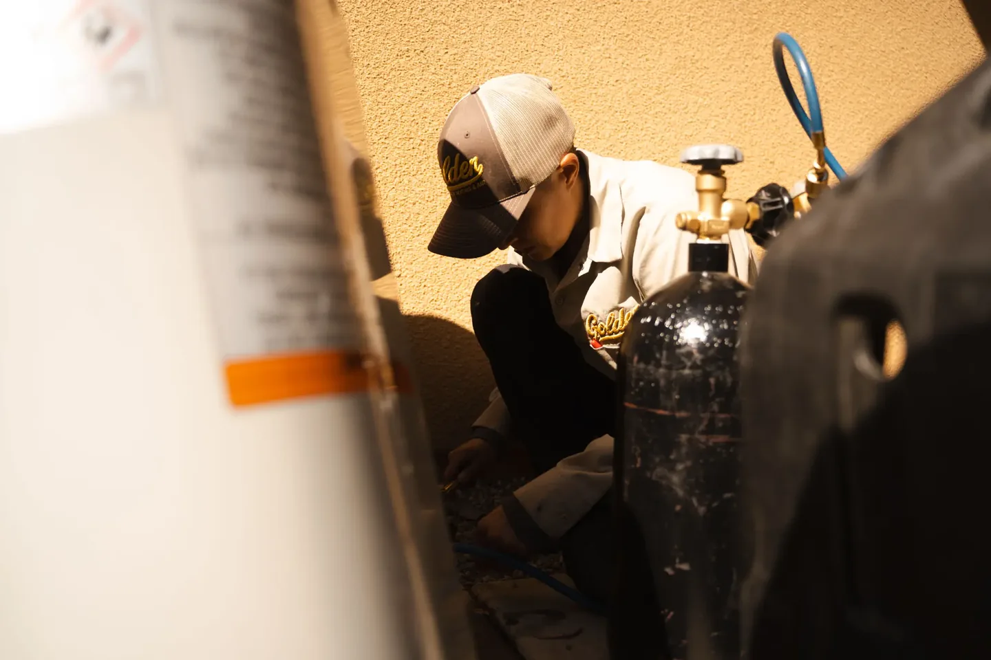 Golden Valley Heating and Air technician servicing outdoor air conditioning equipment — photo 13