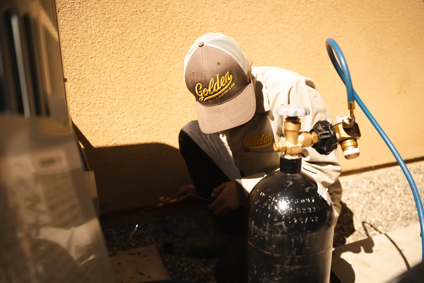 Golden Valley Heating and Air technician servicing outdoor air conditioning equipment — photo 14