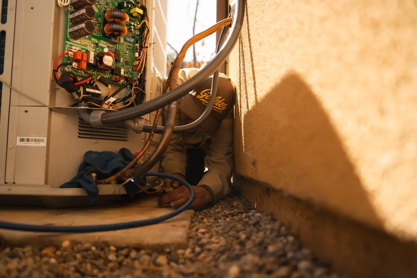 Golden Valley Heating and Air technician servicing outdoor air conditioning equipment — photo 17