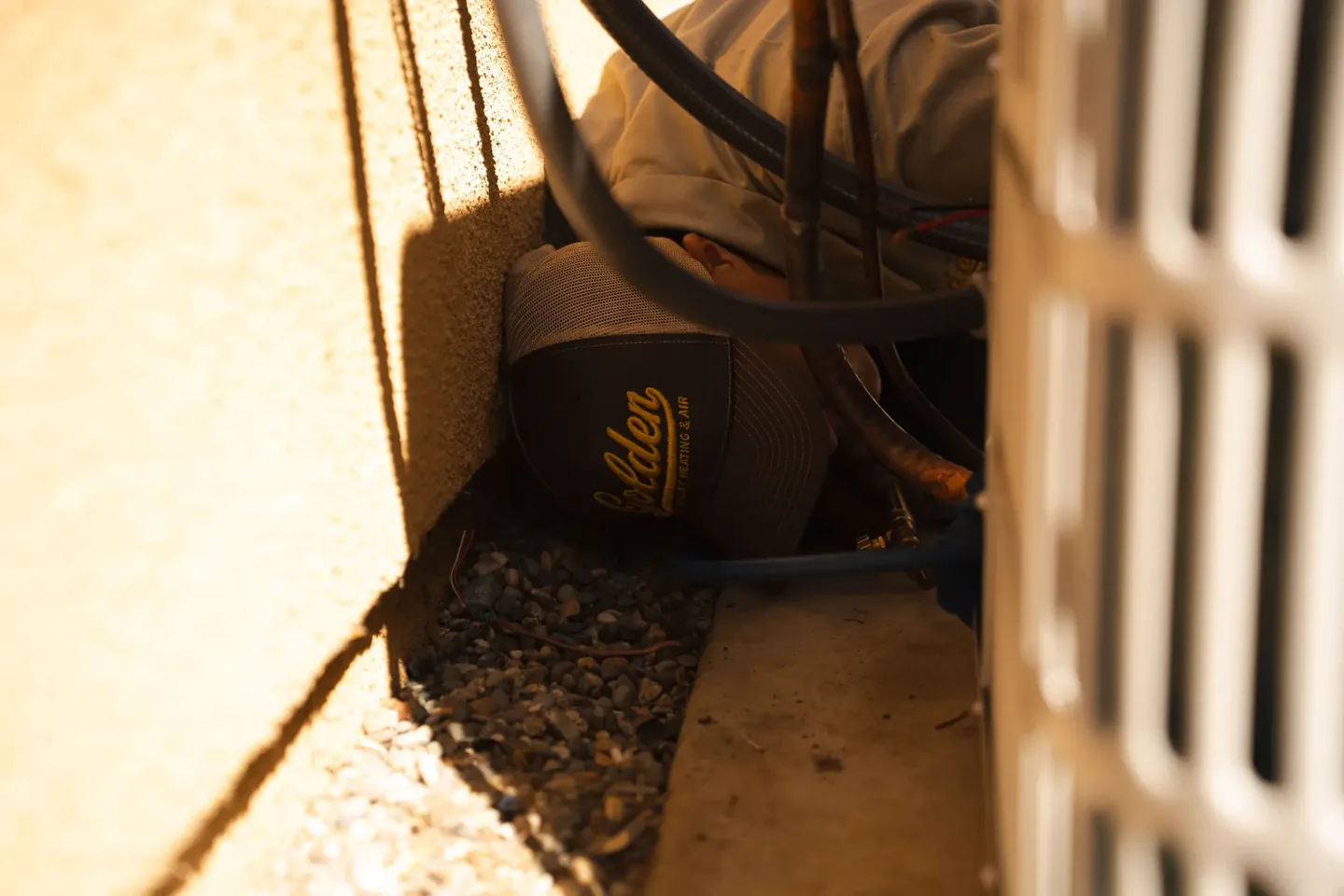 Golden Valley Heating and Air technician servicing outdoor air conditioning equipment — photo 20