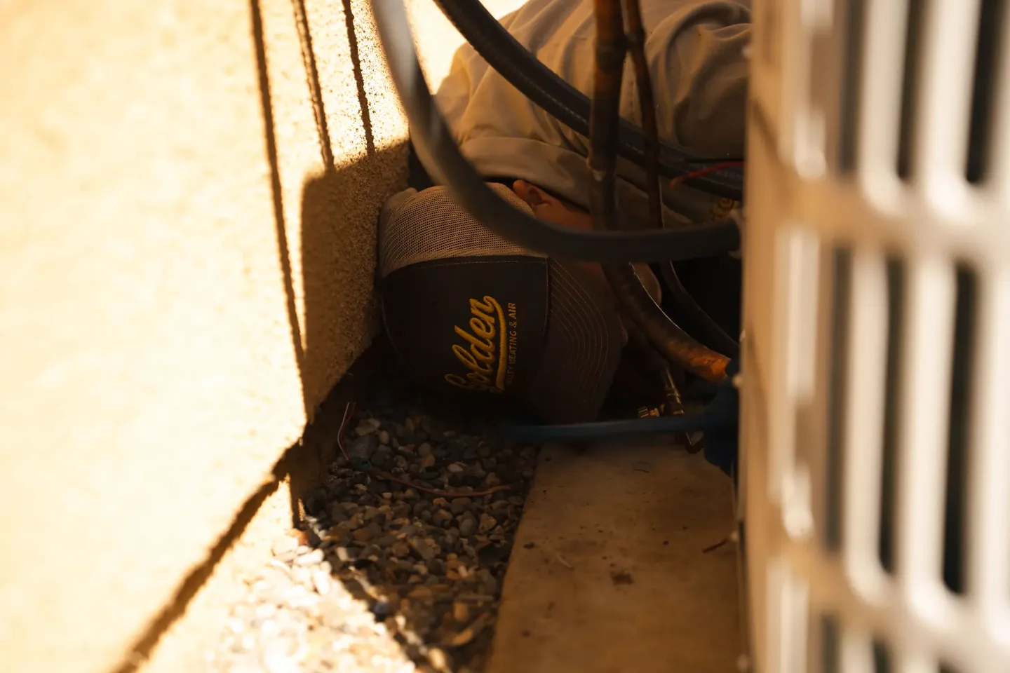 Golden Valley Heating and Air technician servicing outdoor air conditioning equipment — photo 21