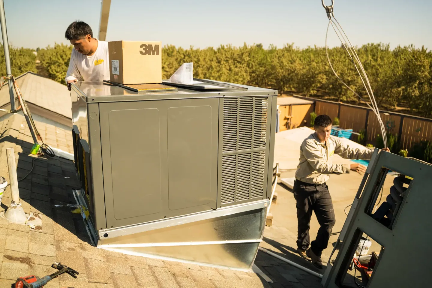 Golden Valley Heating and Air technician servicing rooftop HVAC equipment — photo 1