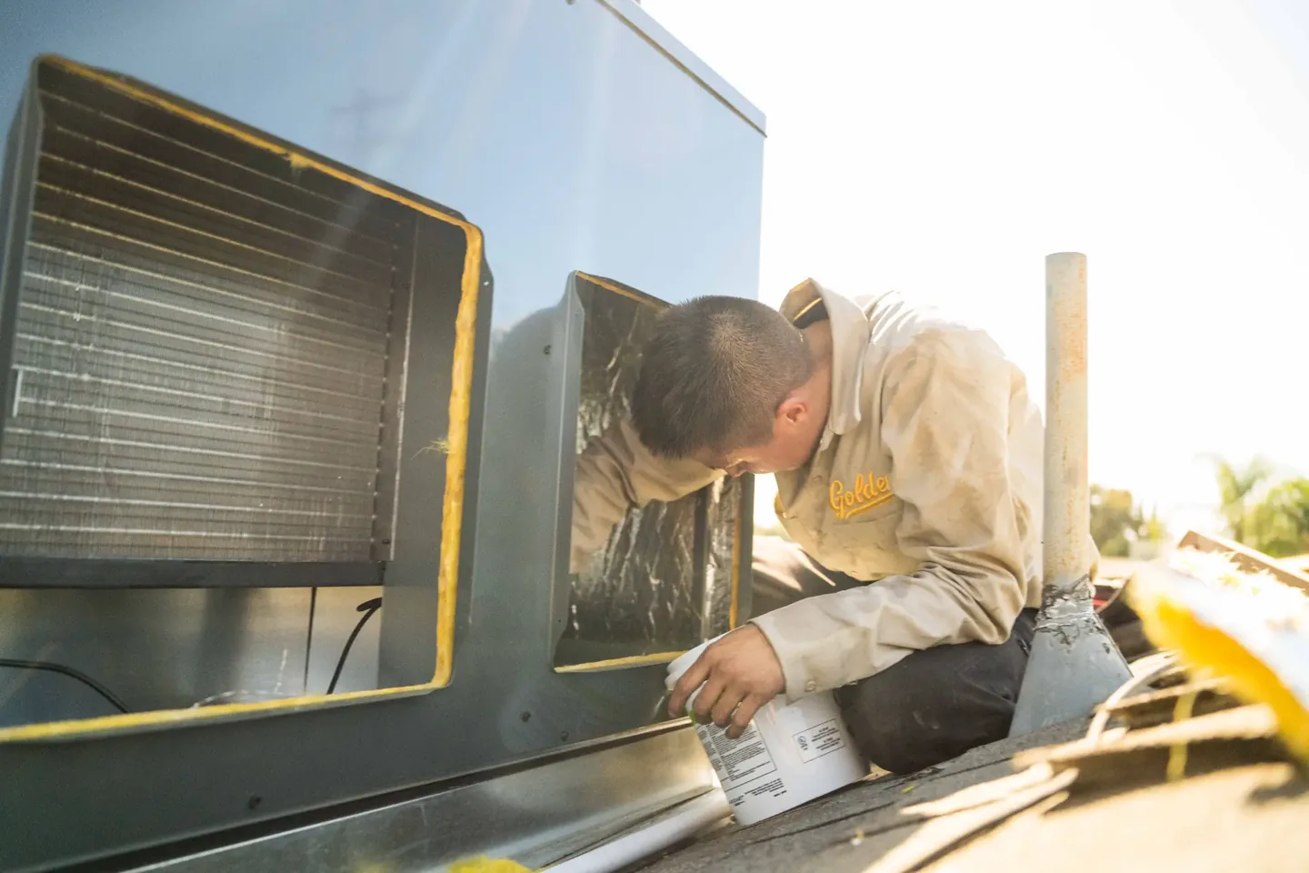 Golden Valley Heating and Air technician servicing rooftop HVAC equipment — photo 8