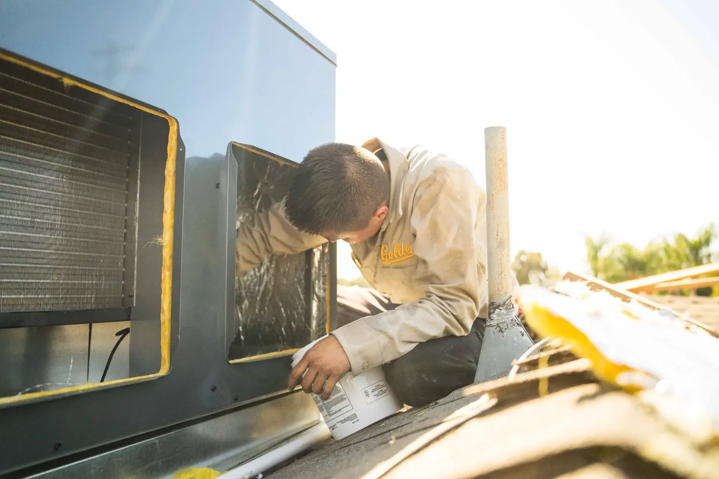 Golden Valley Heating and Air technician servicing rooftop HVAC equipment — photo 9