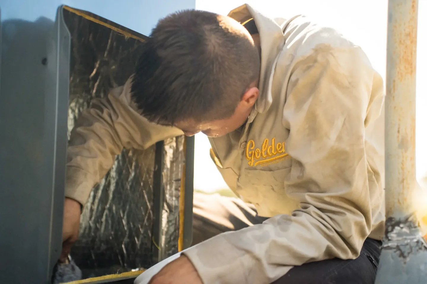 Golden Valley Heating and Air technician servicing rooftop HVAC equipment — photo 10