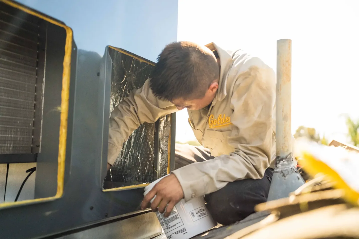 Golden Valley Heating and Air technician servicing rooftop HVAC equipment — photo 11