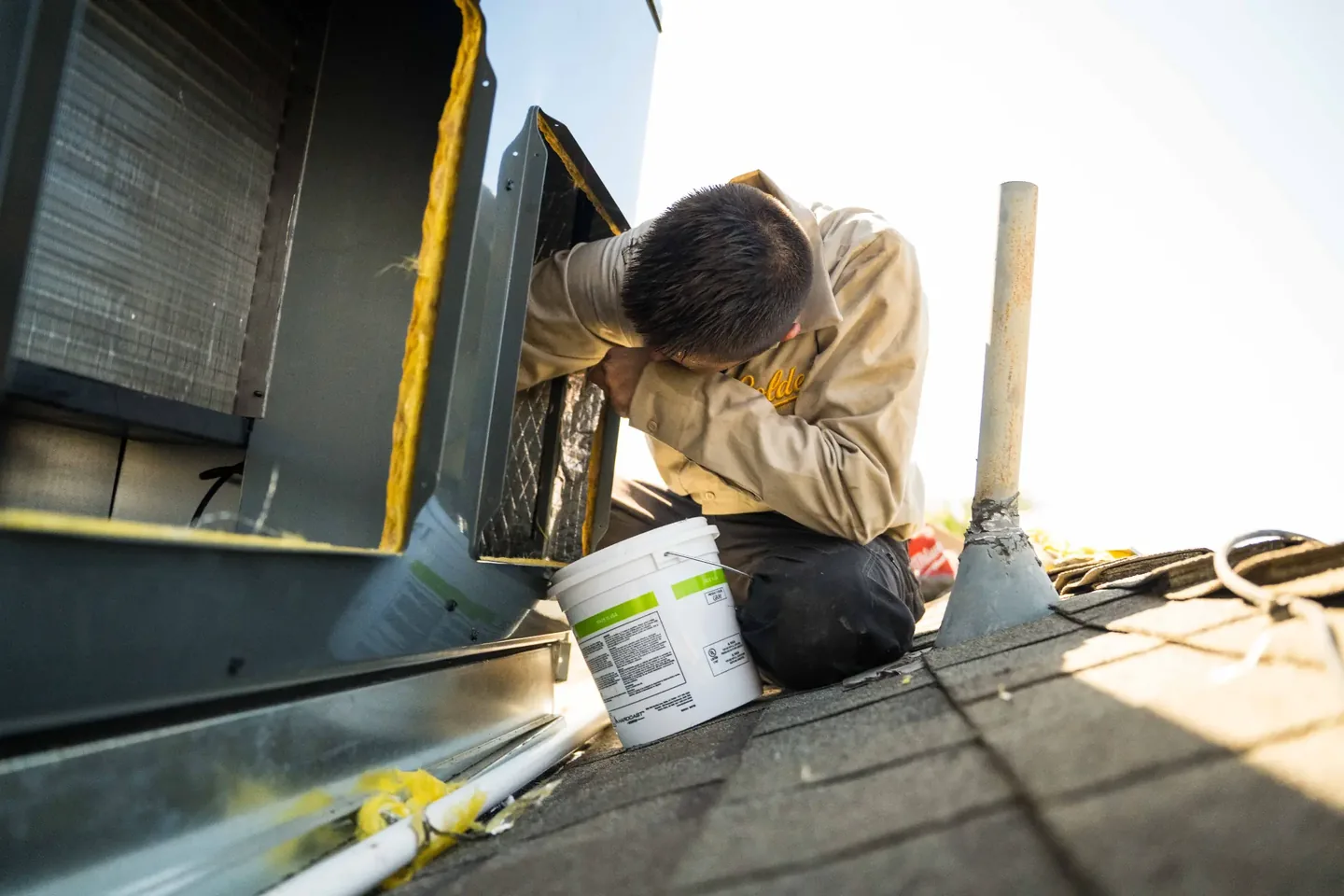 Golden Valley Heating and Air technician servicing rooftop HVAC equipment — photo 12