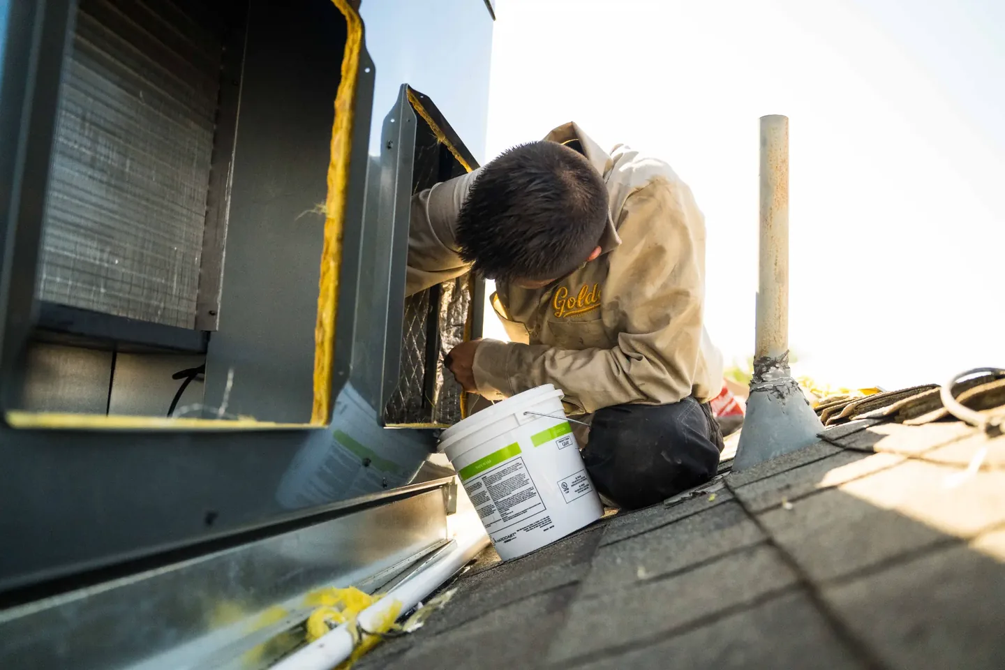 Golden Valley Heating and Air technician servicing rooftop HVAC equipment — photo 13