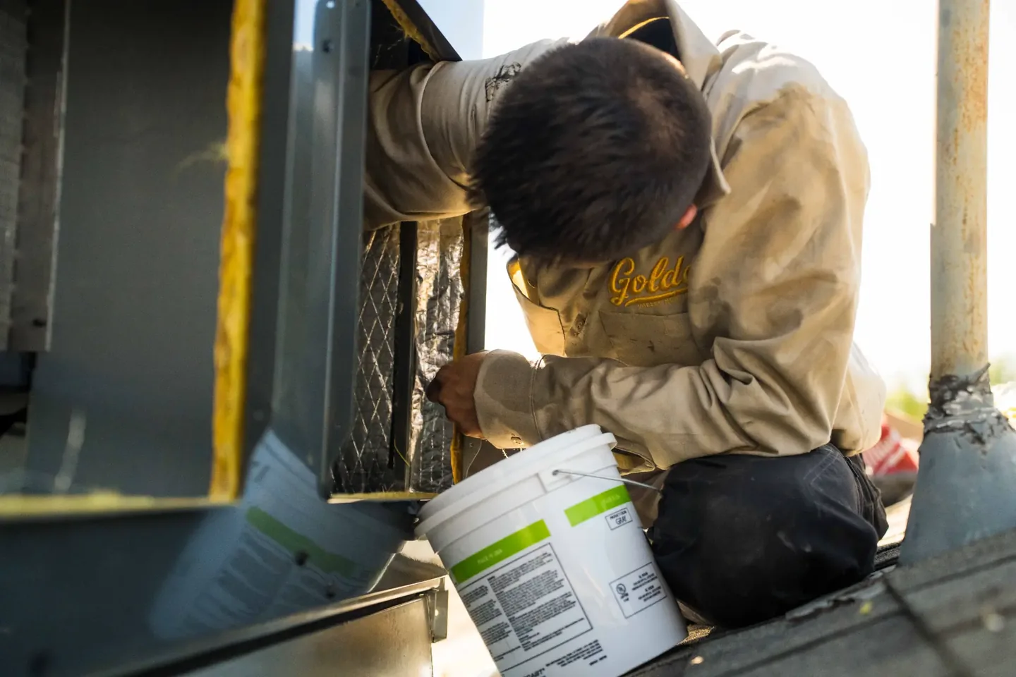 Golden Valley Heating and Air technician servicing rooftop HVAC equipment — photo 14