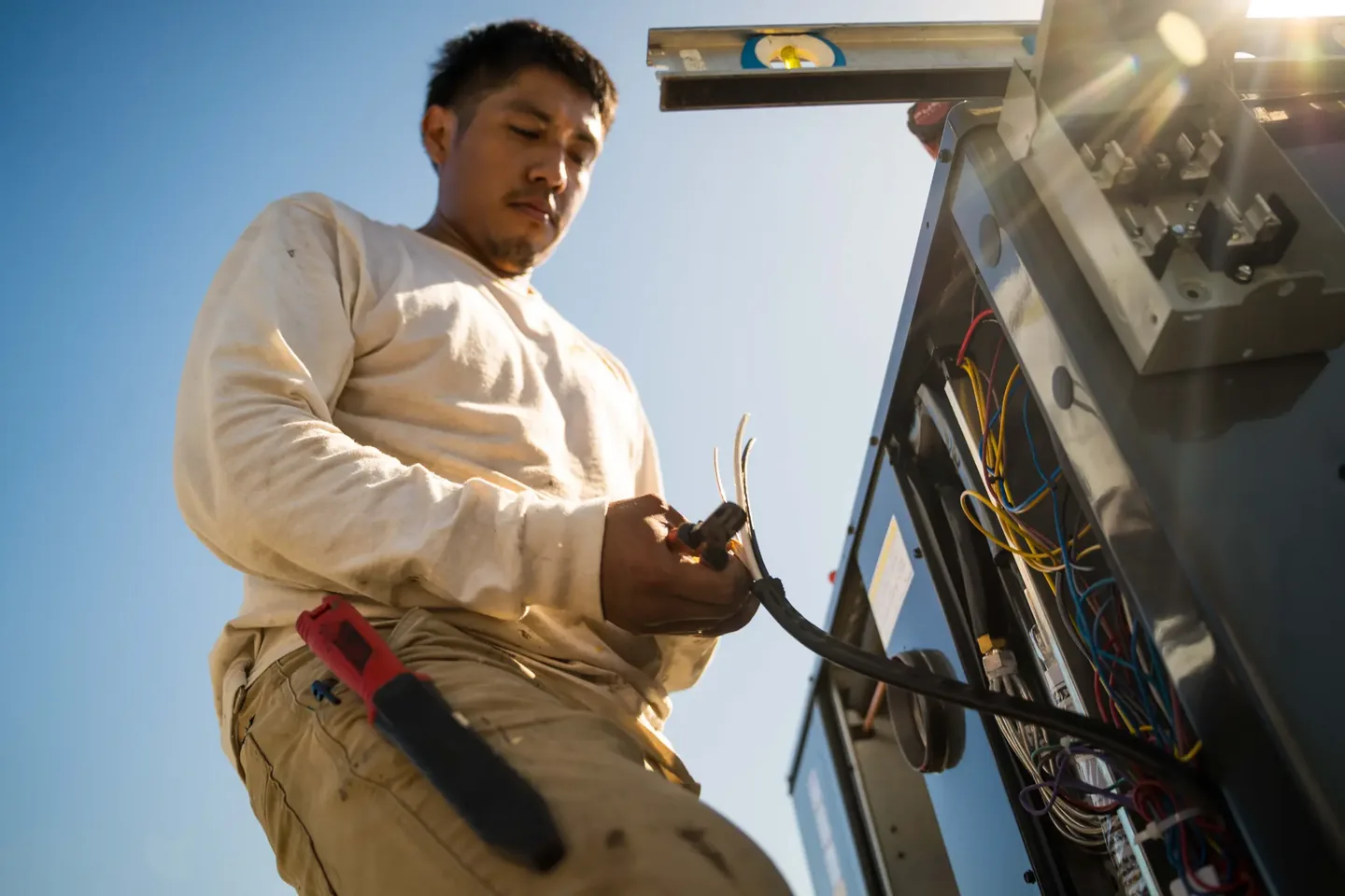 Golden Valley Heating and Air technician servicing rooftop HVAC equipment — photo 15