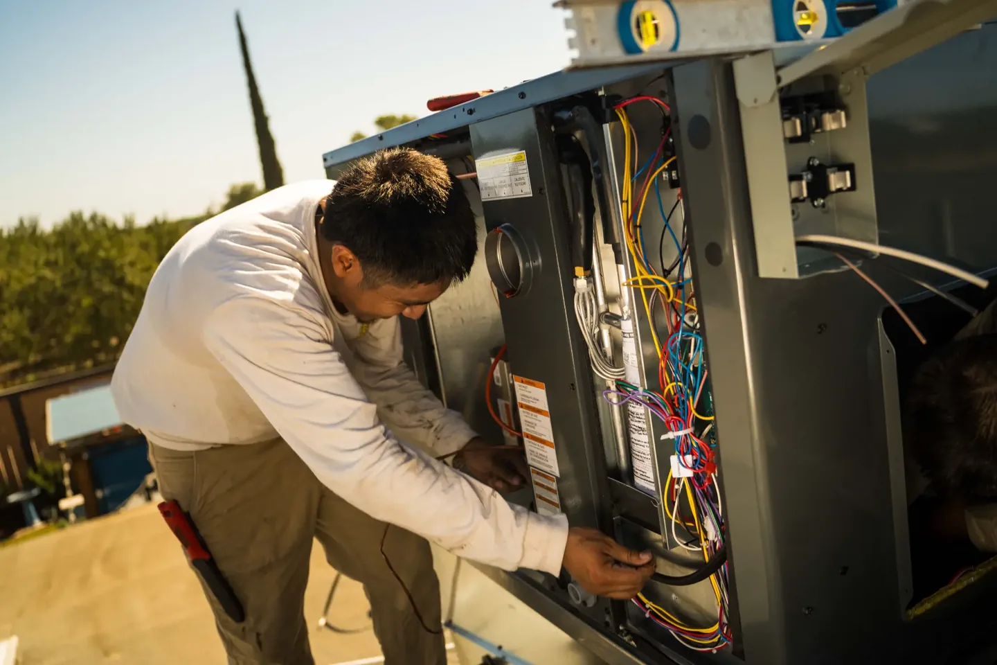 Golden Valley Heating and Air technician servicing rooftop HVAC equipment — photo 19