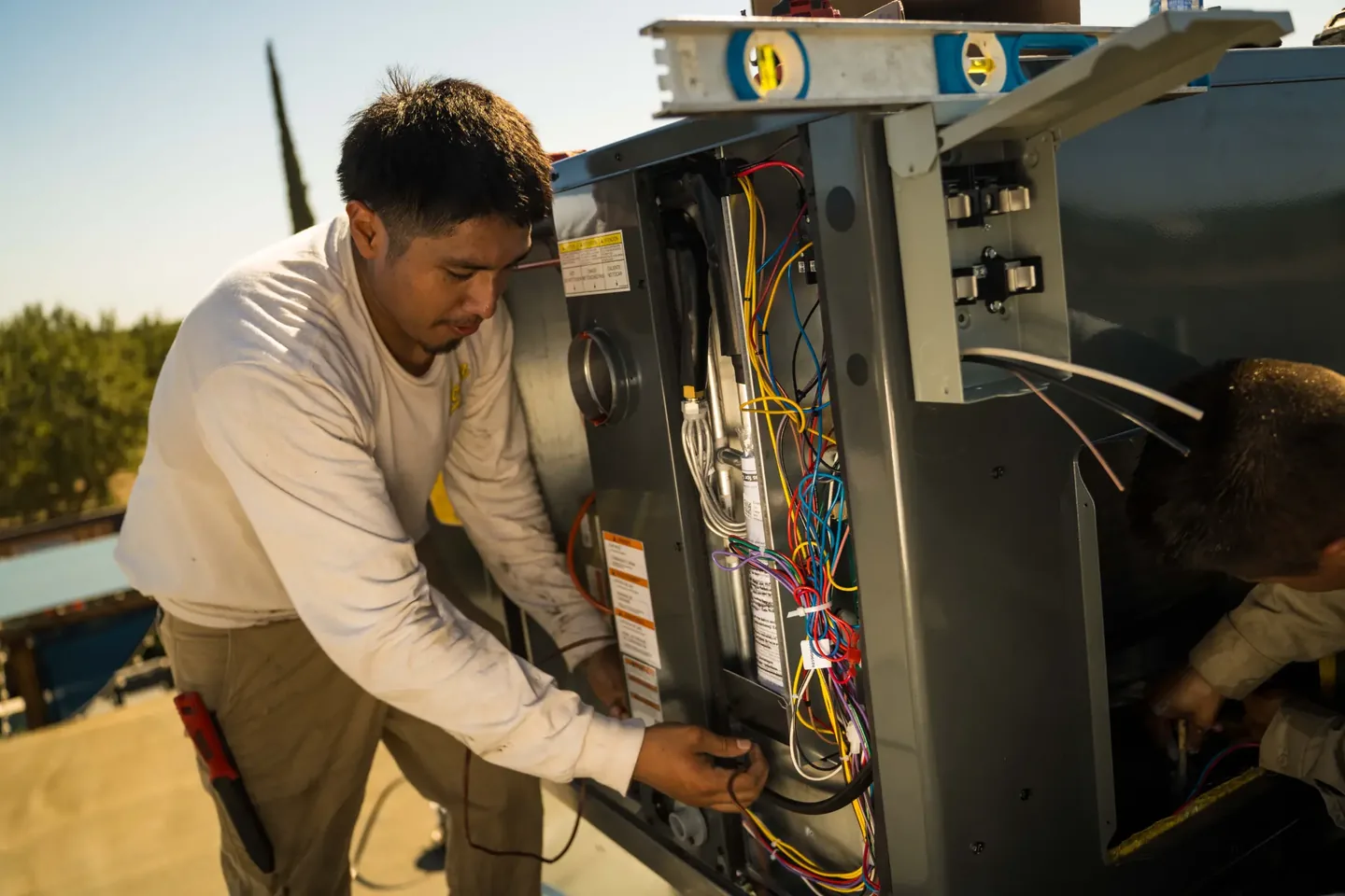 Golden Valley Heating and Air technician servicing rooftop HVAC equipment — photo 20