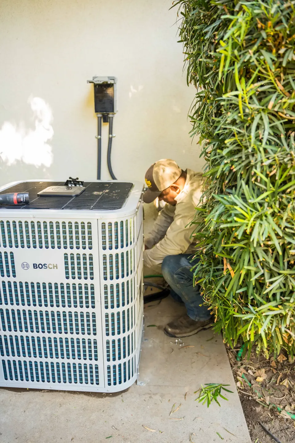 Golden Valley Heating and Air technician servicing outdoor air conditioning equipment — photo 22