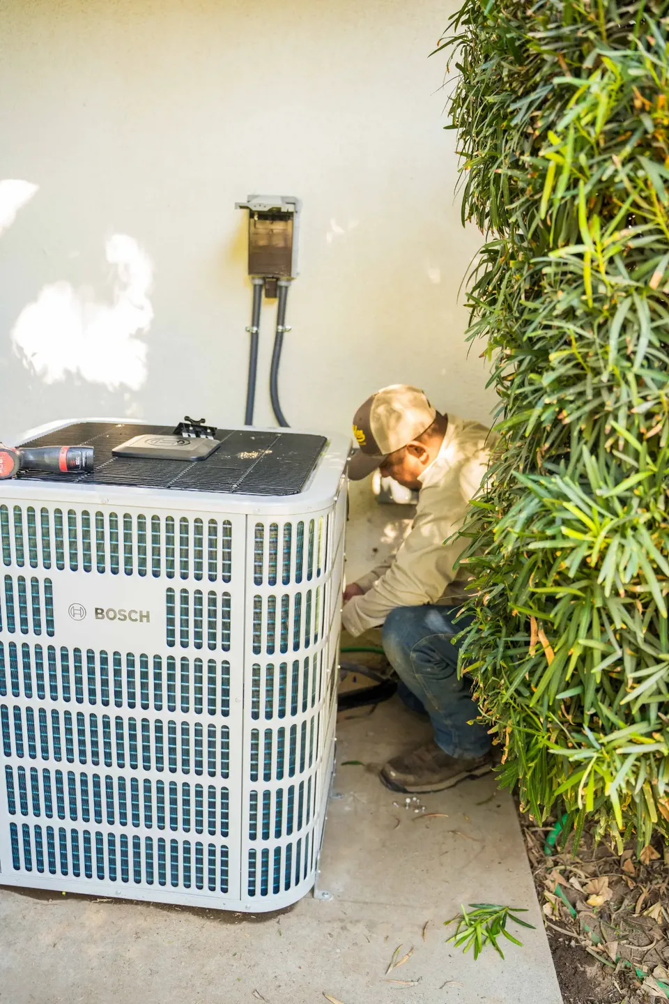 Golden Valley Heating and Air technician servicing outdoor air conditioning equipment — photo 23